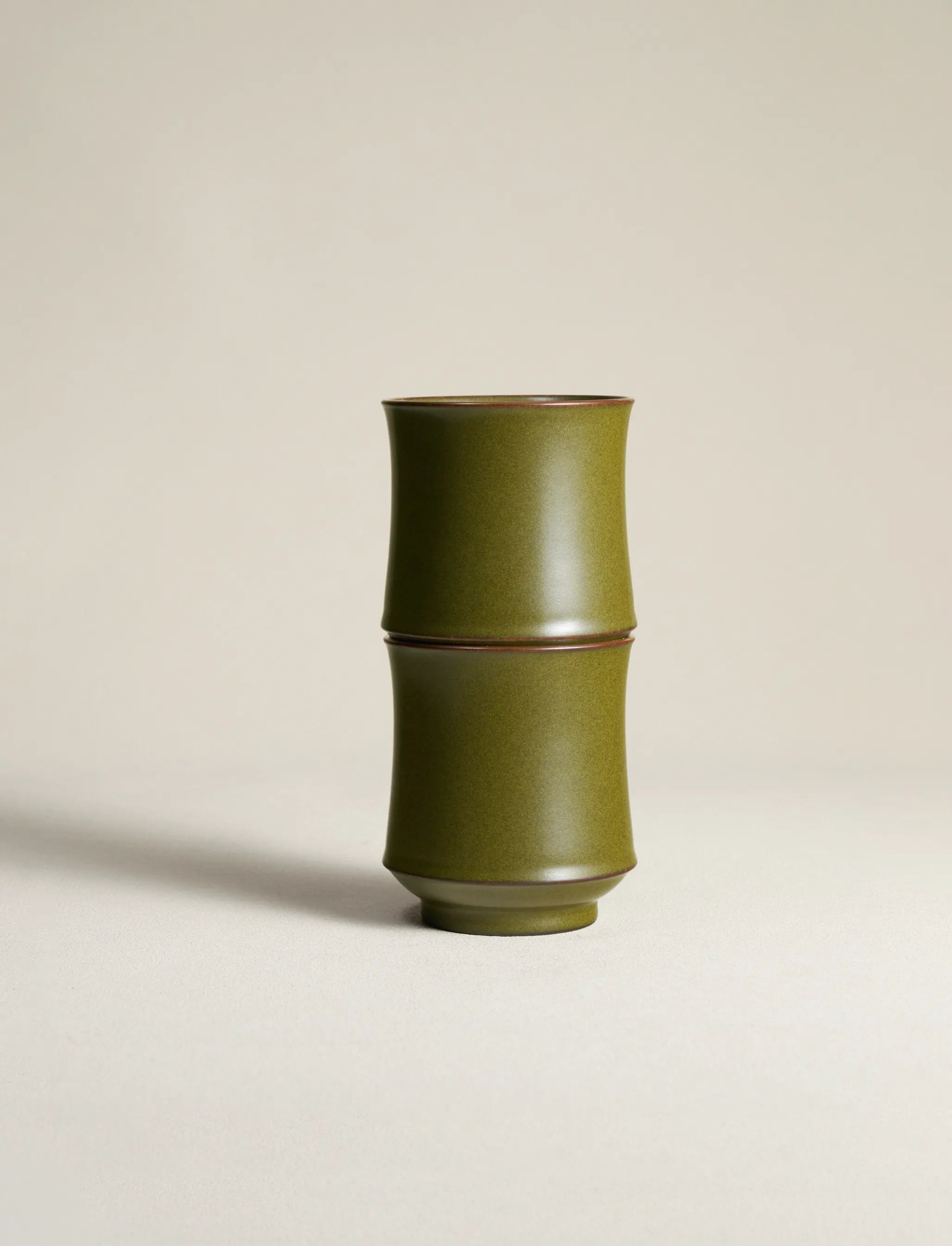 Two SaraGaia Tea-Dust Glaze porcelain cups stacked together, showcasing the precision of the bamboo-shaped design and the rich, natural mineral texture. Lead-free and handcrafted through a traditional 72-step process.