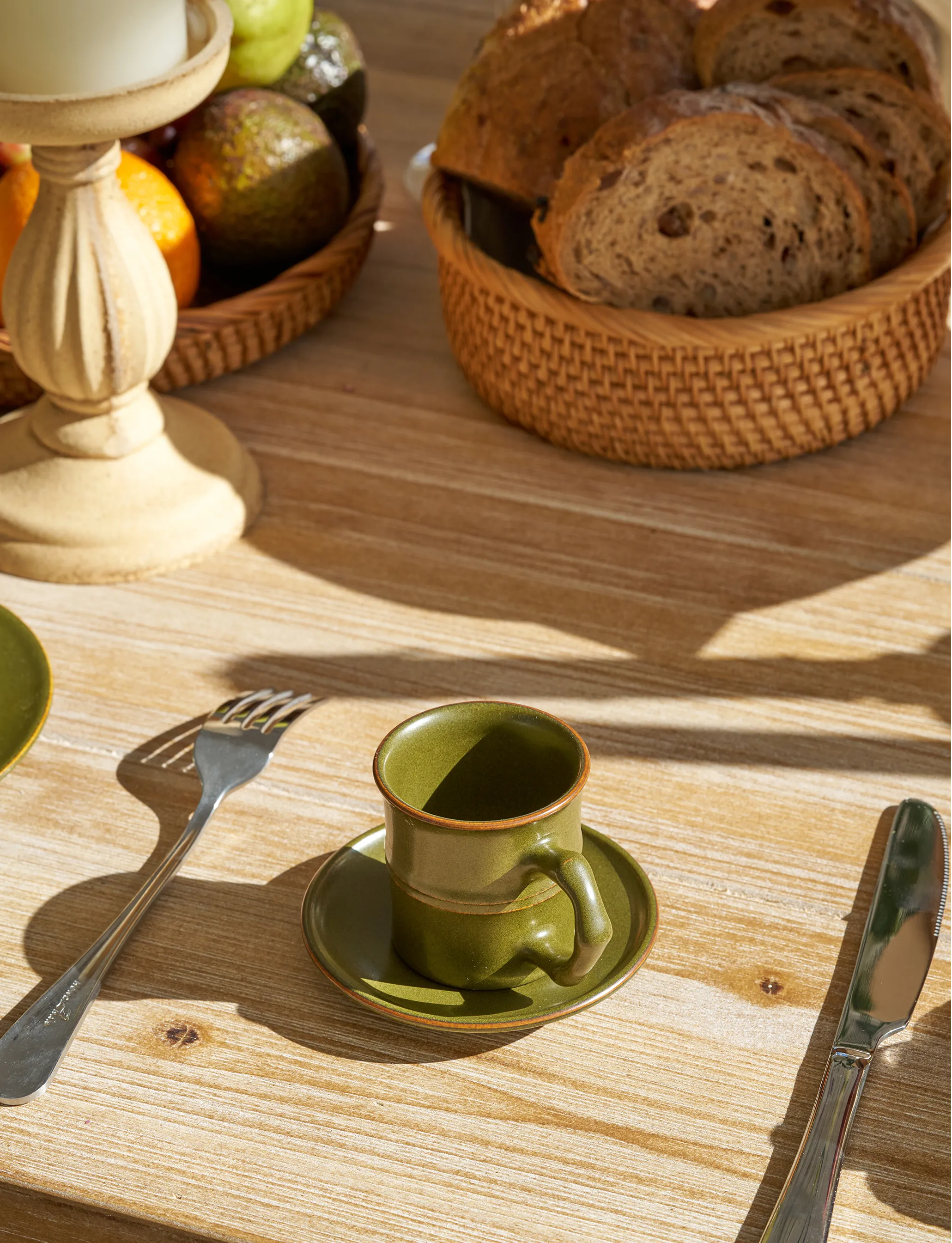 SaraGaia Tea-Dust Glaze bamboo-shaped espresso cup and saucer set on a sunny wooden breakfast table. A lifestyle shot emphasizing the lead-free, high-fire Jingdezhen porcelain in a healthy, artisanal morning setting.