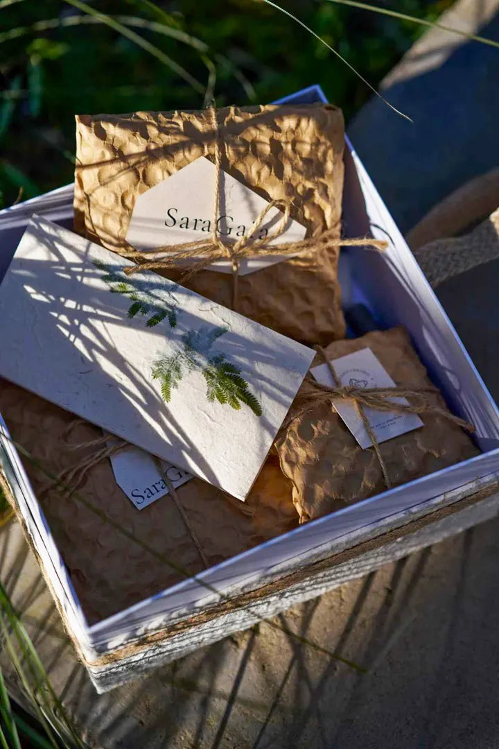Premium gift packaging of a Saragaia ceramic cup with eco-friendly paper and a handmade card.