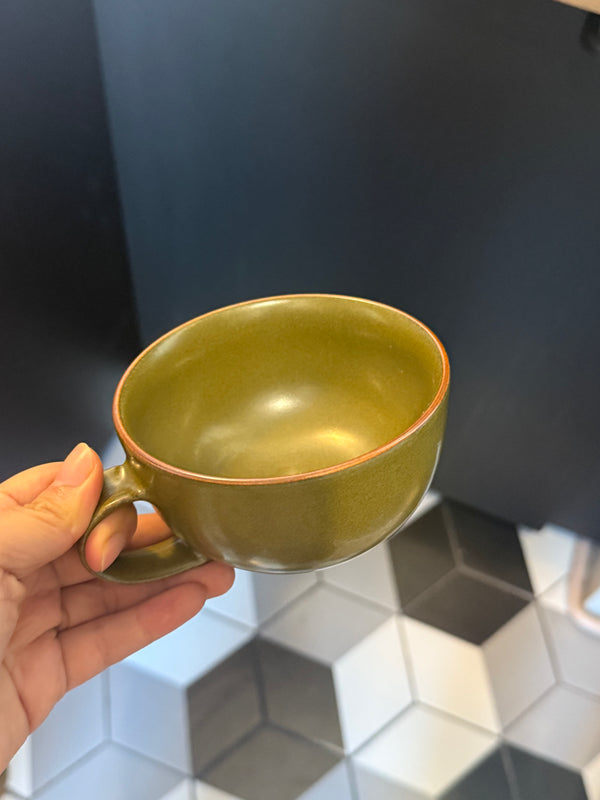 “I love this shade of green glaze — earthy, soft, and perfectly understated. The cup feels solid and reassuring in the hand.”