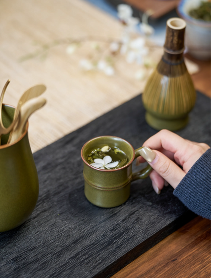 SaraGaia Tea-Dust Glaze bamboo-shaped ceramic mug on a black wood tray, featuring a hand-thrown design and vintage matte mineral finish. Certified lead-free and cadmium-free Jingdezhen porcelain, ideal for a safe and healthy tea ritual.