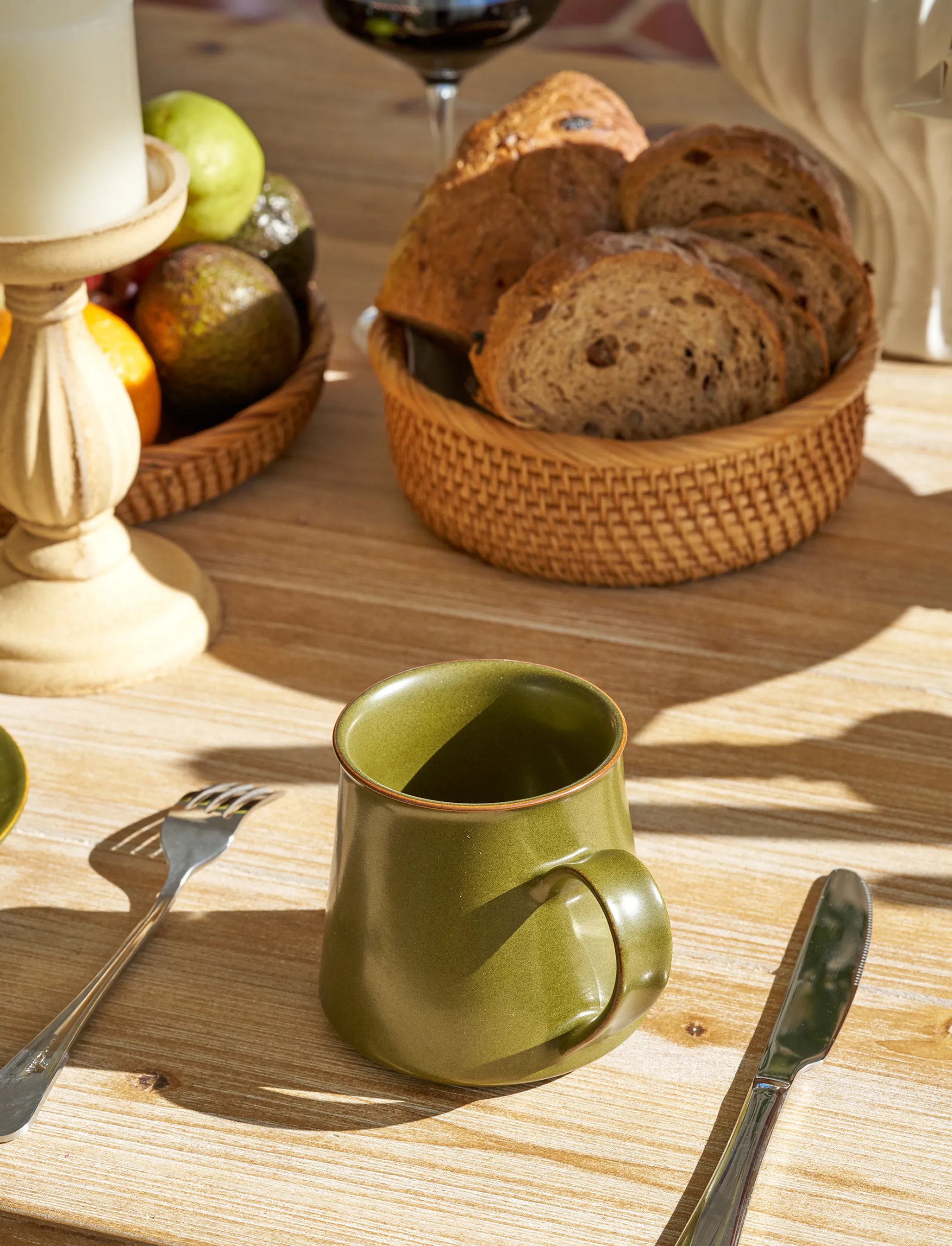 SaraGaia handle mug on a sunlit breakfast table. Artisanal morning ritual.