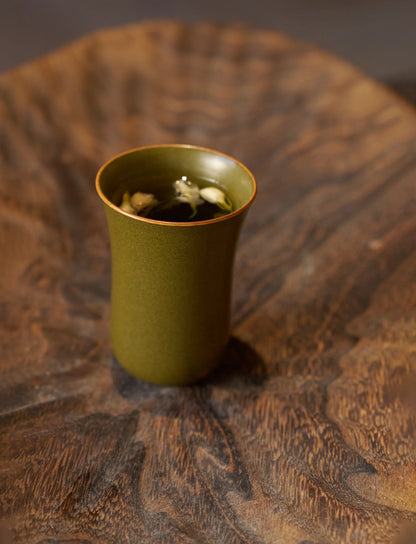 SaraGaia tall tasting cup on a natural wood surface. Zen tea ritual.