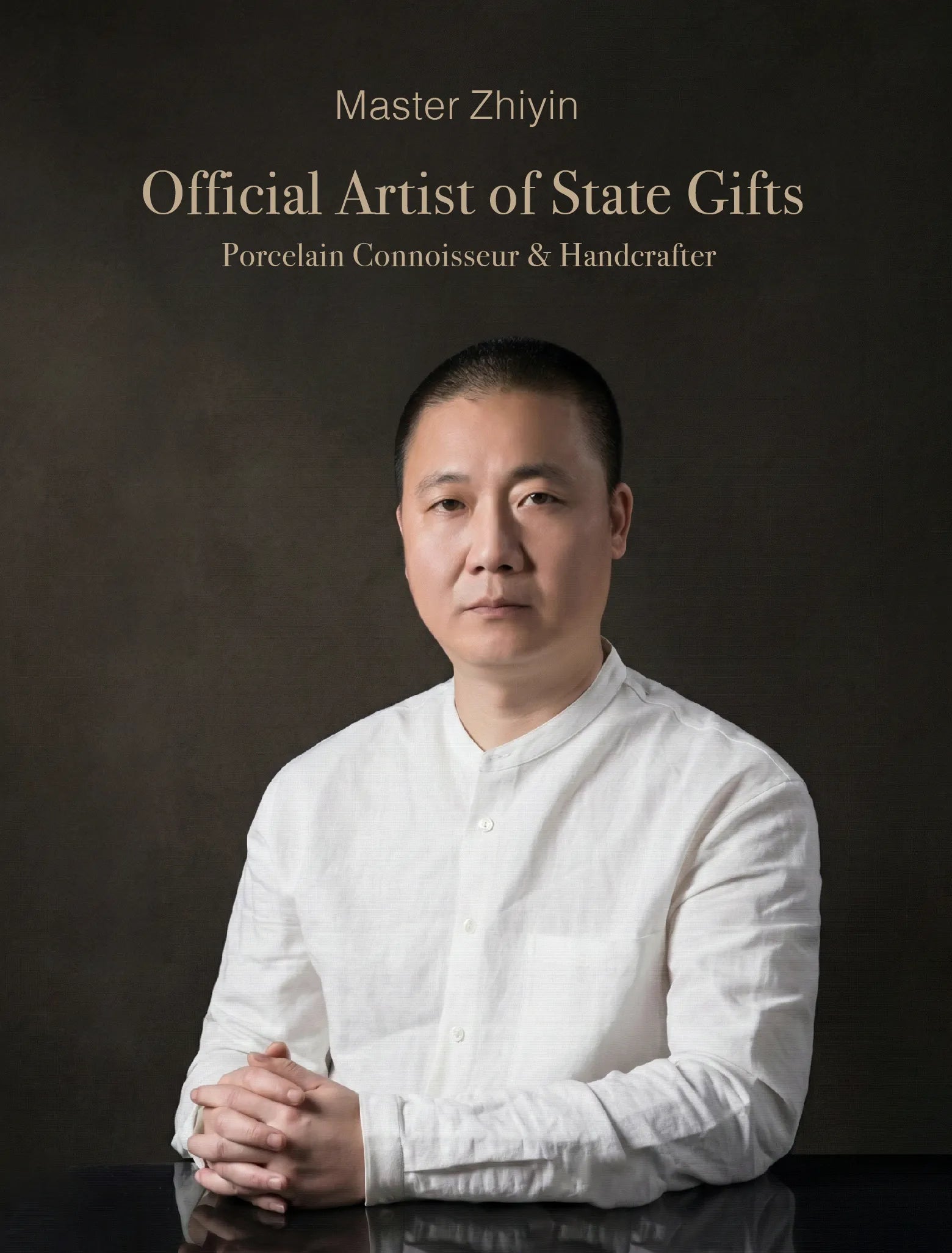 Professional studio portrait of Master Zhiyin, a Senior Porcelain Connoisseur and Official Artist of State Gifts.