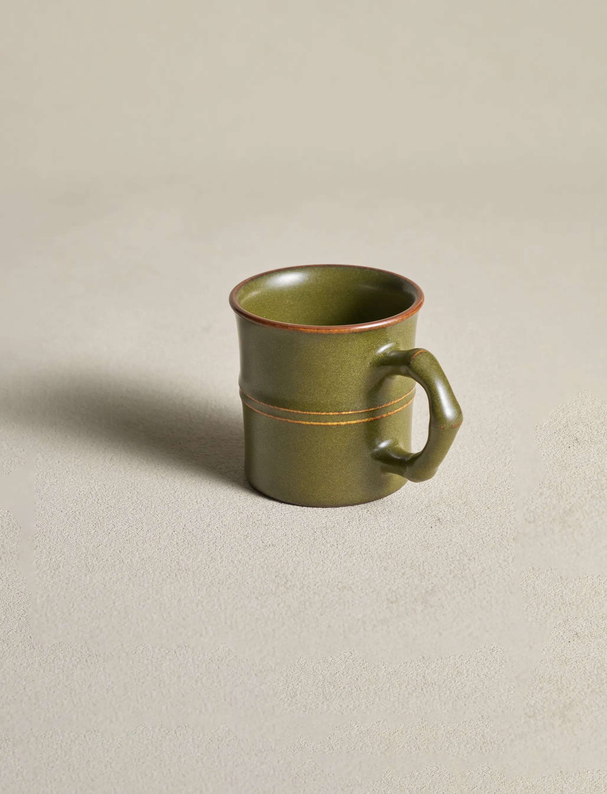 Side profile of Saragaia Tea Dust glaze mug, showing the ergonomic silhouette and bamboo handle