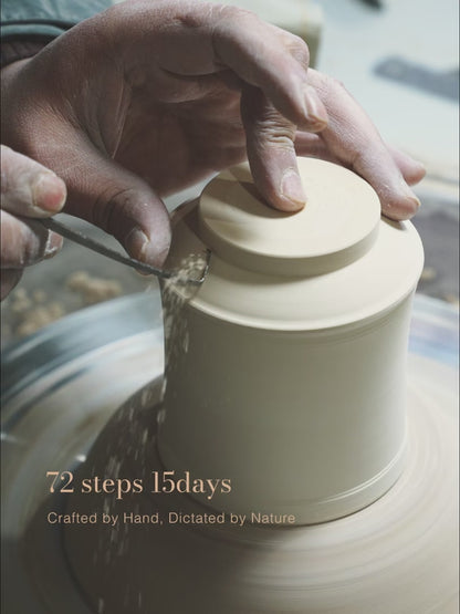 A close-up video of the meticulous hand-trimming process on a pottery wheel, a key part of the 72-step handcrafted journey for a SaraGaia Jingdezhen porcelain cup. This 15-day artisanal creation process ensures each piece achieves its unique, nature-dictated bamboo form.