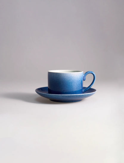 SaraGaia artisan porcelain coffee cup with saucer, featuring gradient sprinkling blue textures.