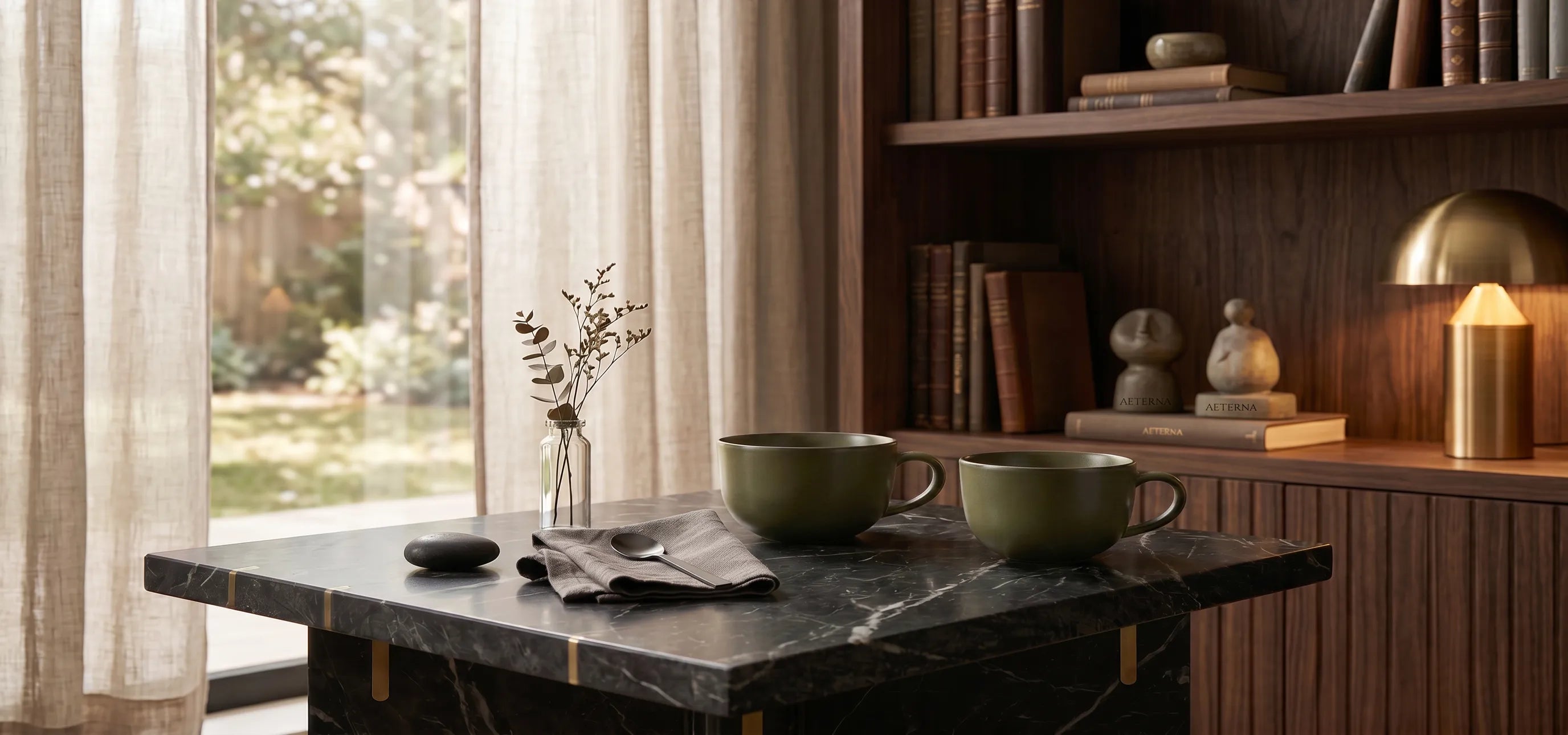 Two Saragaia Jingdezhen ceramic mugs in teadust green glaze on a marble table in a study.
