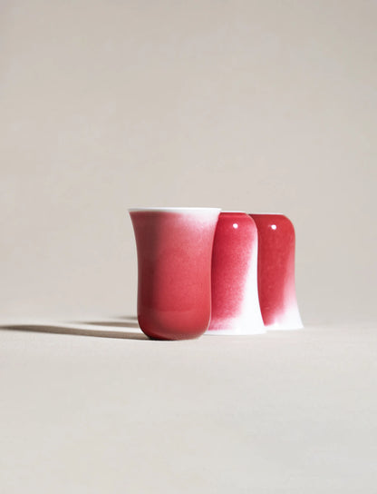 Three SaraGaia tall cups stacked. Elegant red to white gradient glaze.