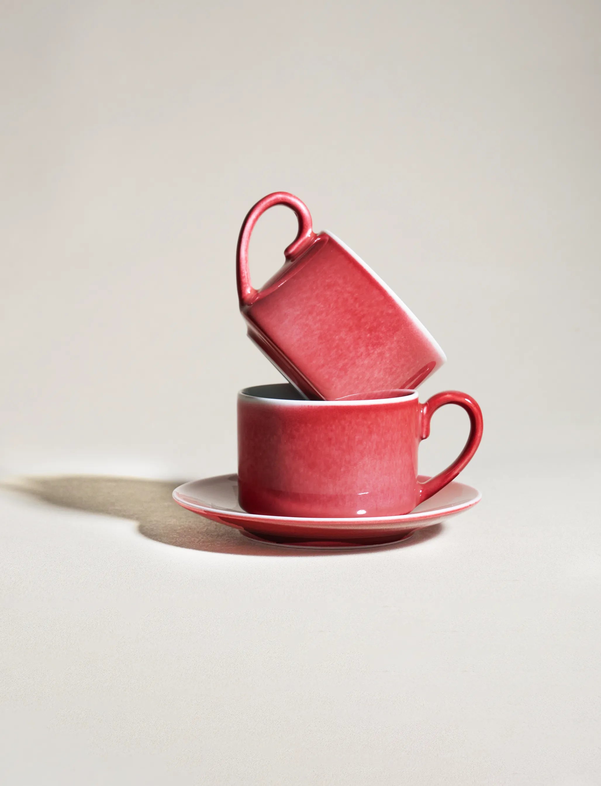 Two SaraGaia espresso cups with handles stacked. Unique gradient glaze.