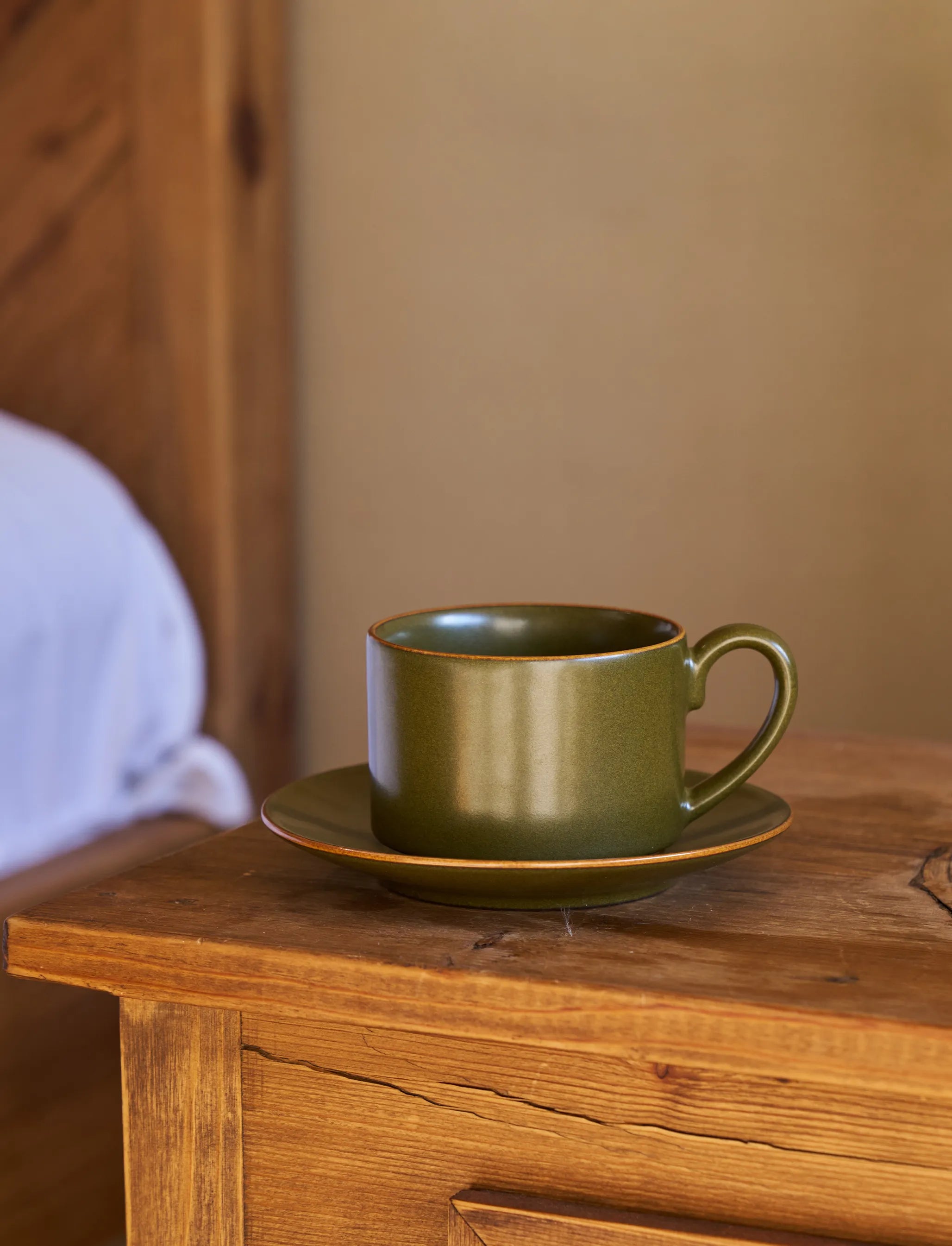 SaraGaia espresso cup on a rustic wood table. Lifestyle tea ritual.